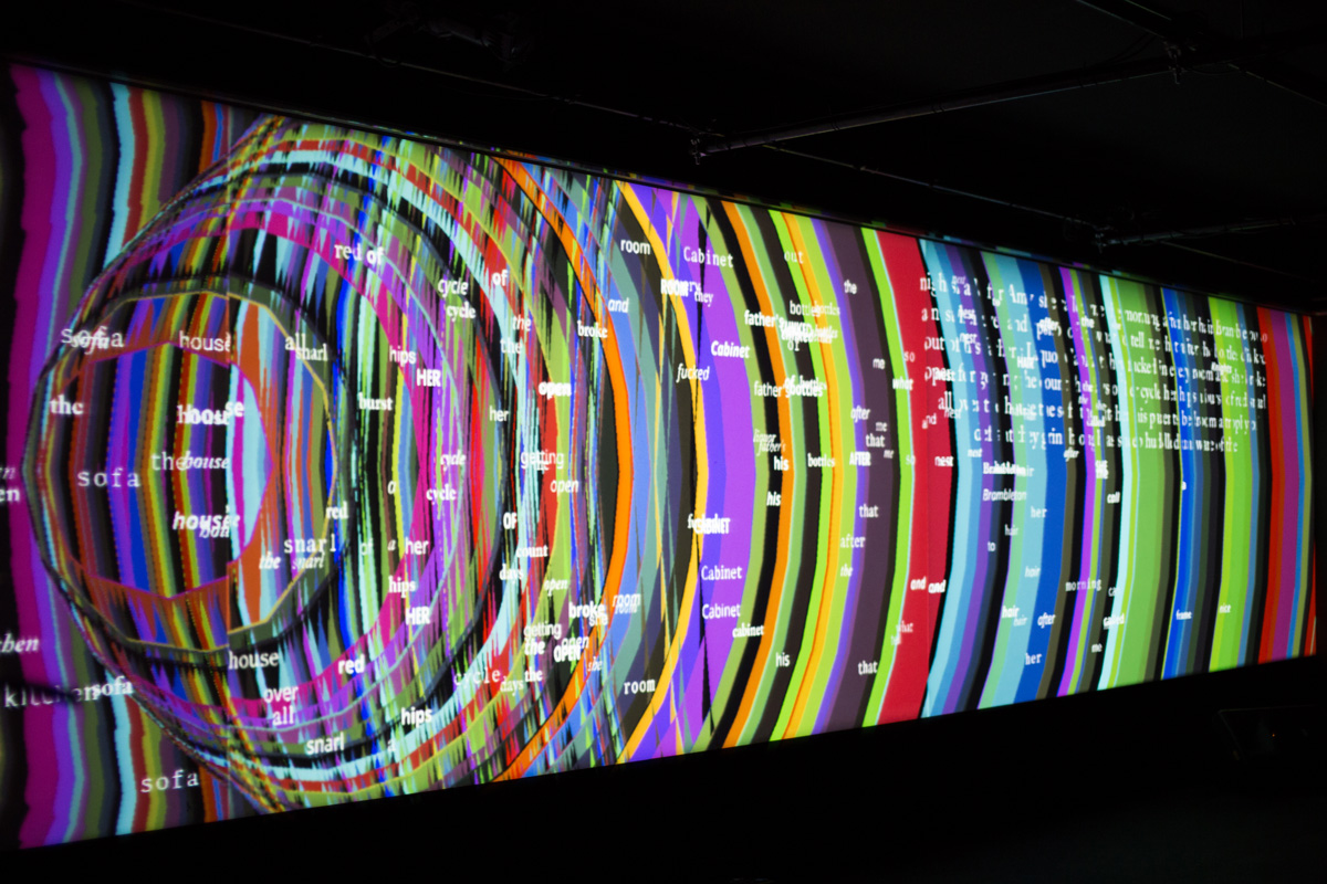 Concentric circles of color and words traveling across a screen
